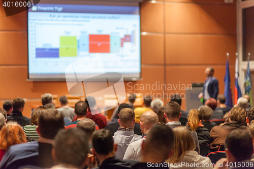 Image of Business speaker giving a talk in conference hall.