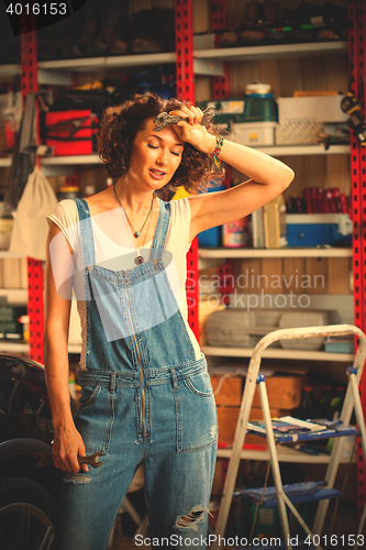 Image of portrait of a beautiful mechanic woman