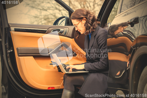 Image of business woman with a notebook on her lap