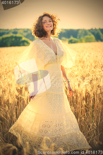 Image of Beautiful smiling woman dancing on the summer Field