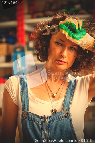 Image of portrait of a auto mechanic woman wiping the face