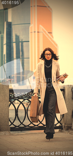 Image of citizen with a wooden case and books in the city