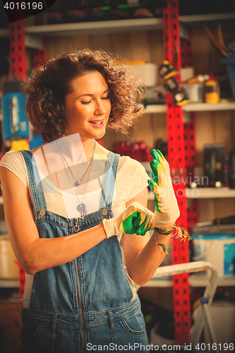 Image of woman mechanic wearing protective gloves