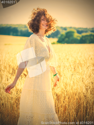 Image of beautiful brunette woman in a field