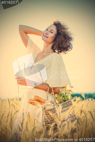 Image of beautiful smiling woman outdoors in barley field