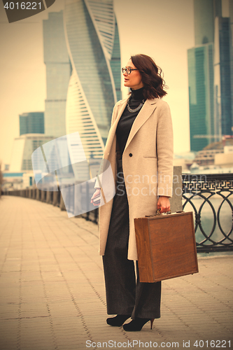 Image of woman holding old wooden case