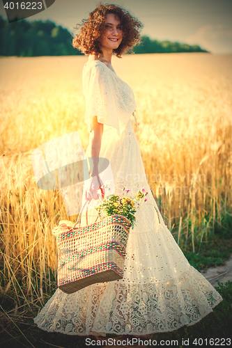 Image of beautiful smiling woman in white syled dress outdoors