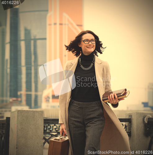 Image of smiling middle aged brunette in the business district of the cit