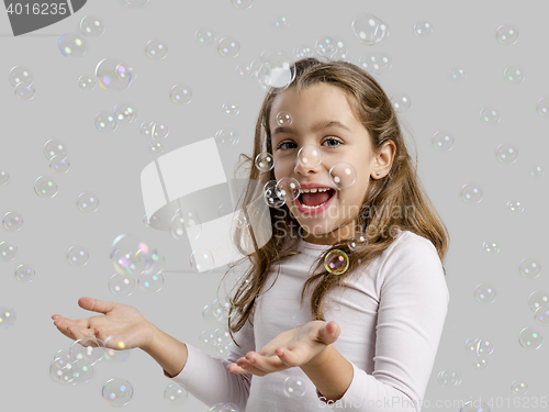 Image of Girl playing with soap bubbles