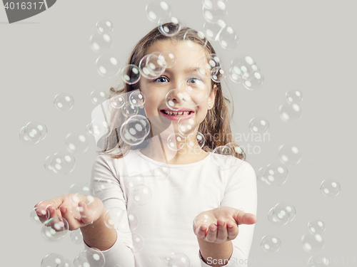 Image of Girl playing with soap bubbles