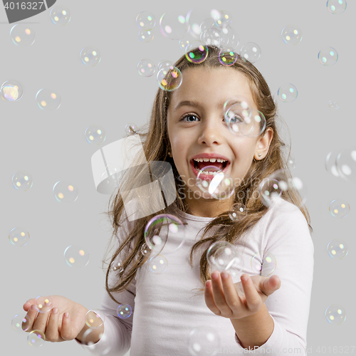 Image of Girl playing with soap bubbles