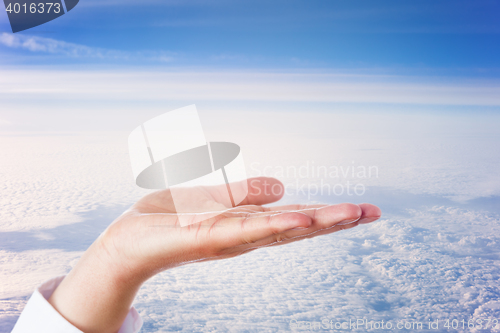 Image of Open Palm Of Hand High Above The Clouds