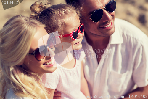 Image of happy family in sunglasses on summer beach