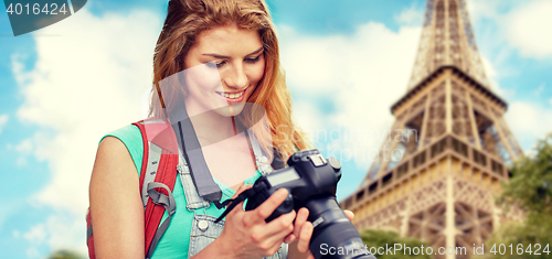 Image of woman with backpack and camera over eiffel tower