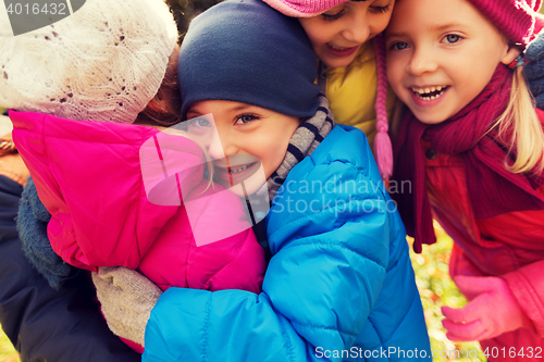 Image of group of happy children hugging in autumn park