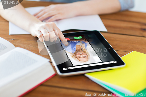 Image of close up of student with tablet pc and notebook