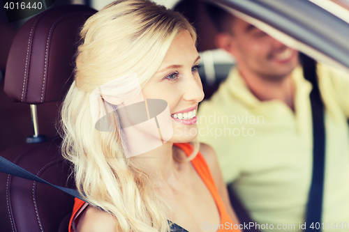 Image of happy man and woman driving car