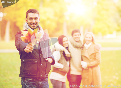 Image of group of friends having fun in autumn park