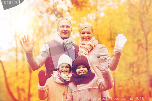 Image of happy family in autumn park