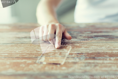 Image of close up of woman with transparent smartphone