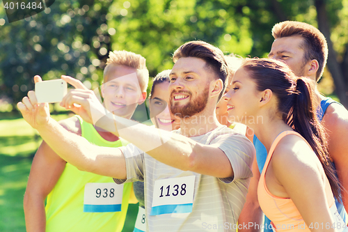 Image of teenage sportsmen taking selfie with smartphone