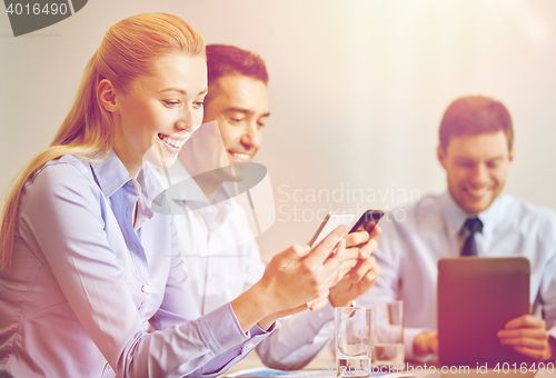 Image of businesspeople with smartphones and tablet pc