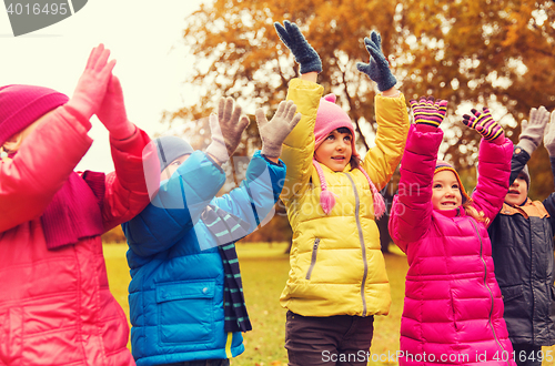 Image of group of happy children having fun in autumn park