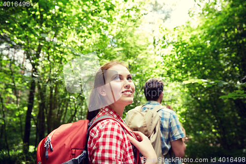 Image of group of smiling friends with backpacks hiking