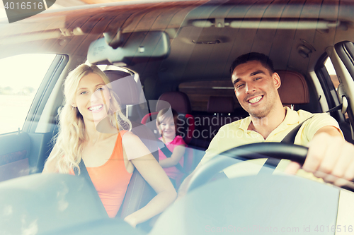 Image of happy family with little child driving in car