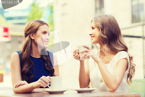 Image of young women drinking coffee and talking at cafe