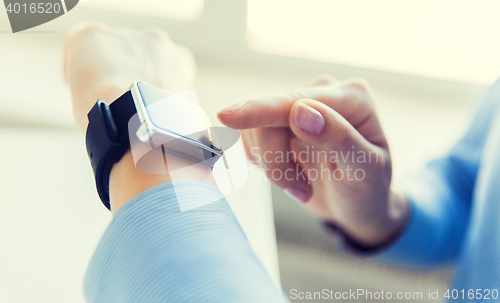 Image of close up of hands setting smart watch