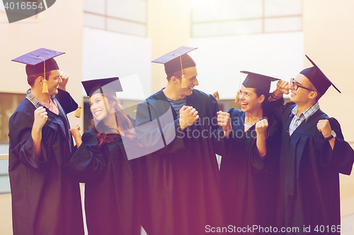 Image of group of smiling students in mortarboards