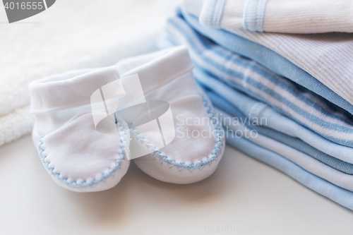 Image of close up of baby bootees and clothes for newborn