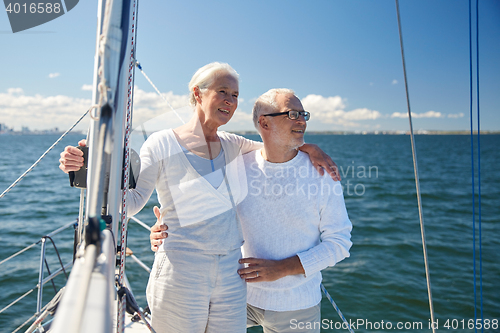 Image of senior couple hugging on sail boat or yacht in sea