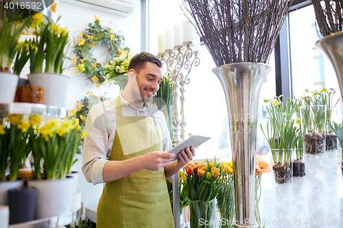 Image of man with tablet pc computer at flower shop