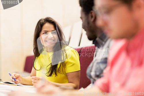 Image of  international students talking on lecture 