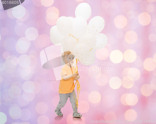 Image of happy little baby boy with bunch of balloons