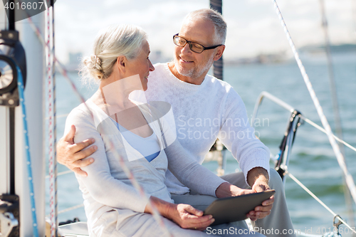 Image of senior couple with tablet pc on sail boat or yacht