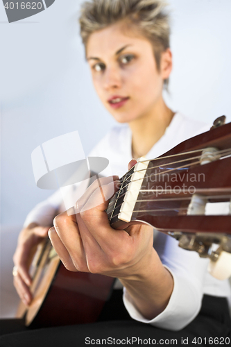 Image of woman and guitar