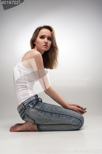 Image of Pretty sad woman on floor