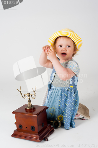 Image of Little baby girl with retro phone