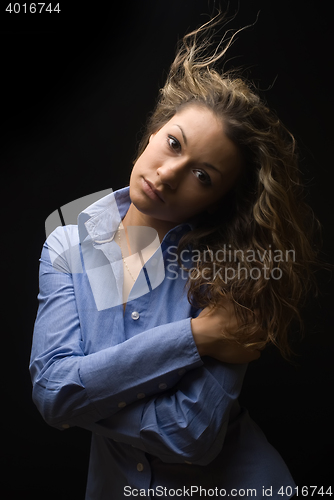 Image of Attractive brunette woman in blue shirt