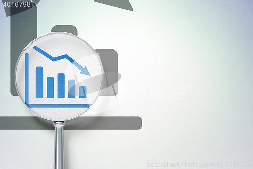 Image of News concept:  Decline Graph with optical glass on digital background