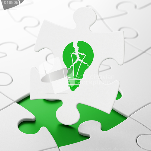 Image of Business concept: Light Bulb on puzzle background