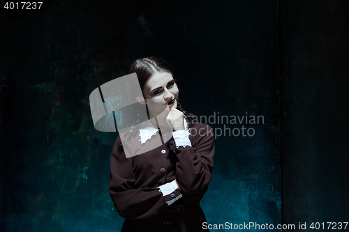 Image of Portrait of a young smiling girl in school uniform as killer woman