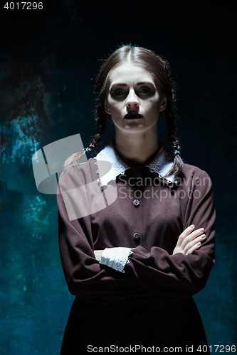 Image of Portrait of a young girl in school uniform as killer woman