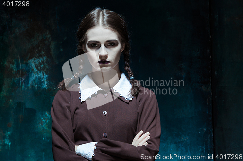 Image of Portrait of a young girl in school uniform as killer woman