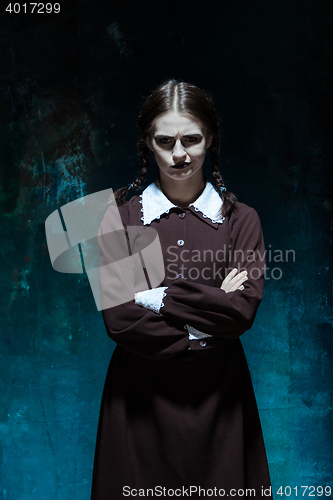 Image of Portrait of a young girl in school uniform as killer woman