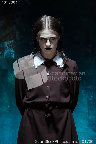 Image of Portrait of a young girl in school uniform as killer woman