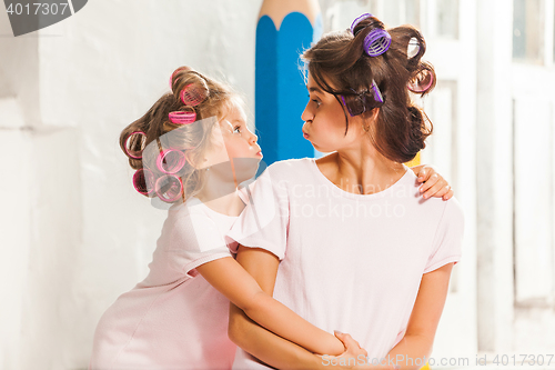 Image of Little girl playing with her mother